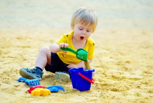 Toddler plays sand