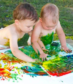 Children do finger painting on wide space